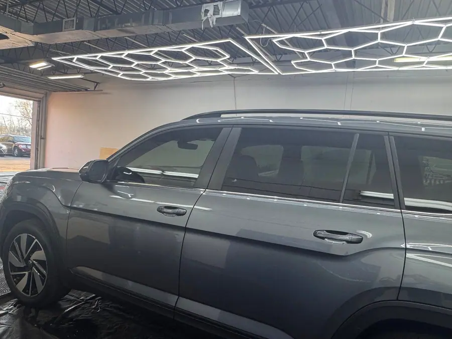 Grey Volkswagen SUV with tinted windows in side profile