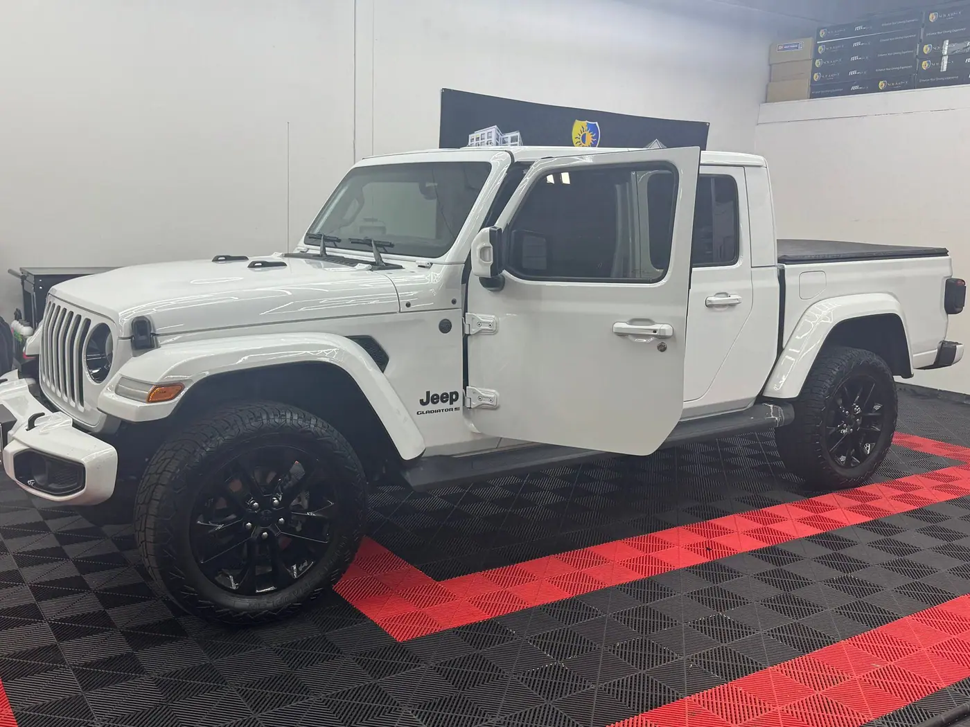 Jeep Gladiator with tinted windows in the shop bay