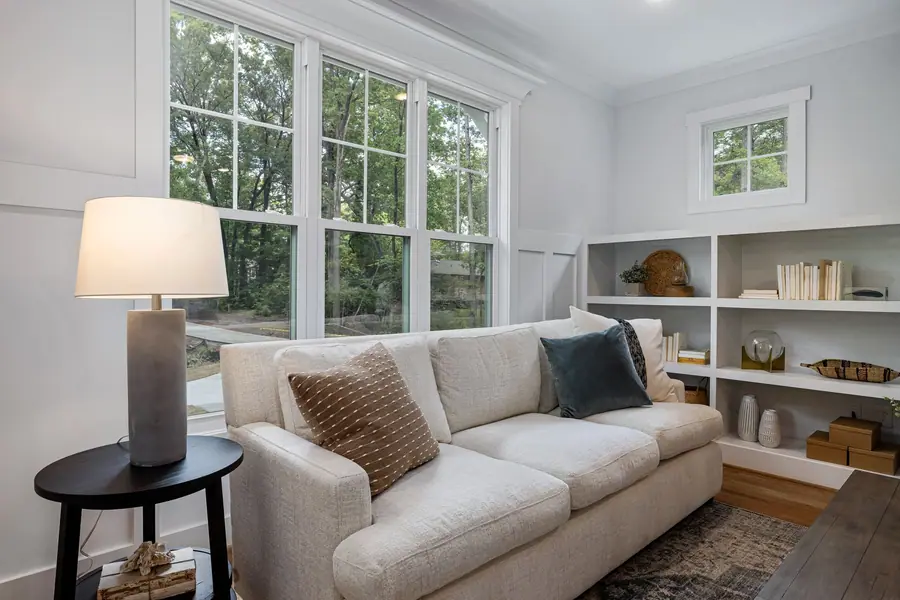 Bright living room with a tall bank of windows and a white sofa
