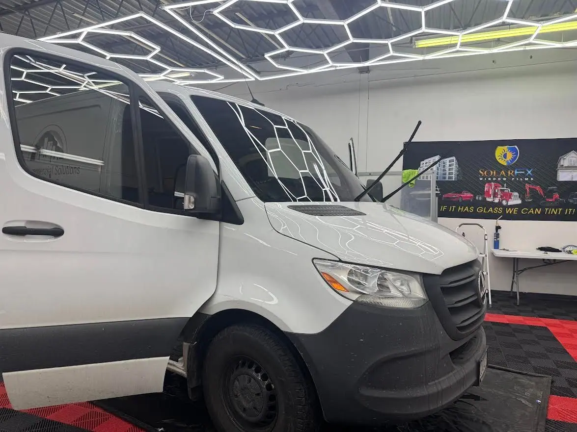 White Mercedes Sprinter van with tinted windows in the shop
