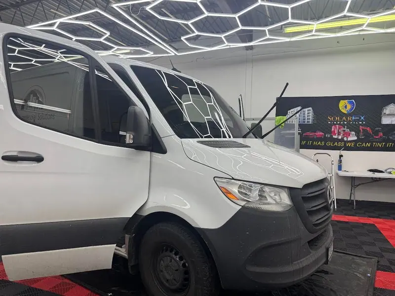 White Mercedes Sprinter van with tinted windows in the shop
